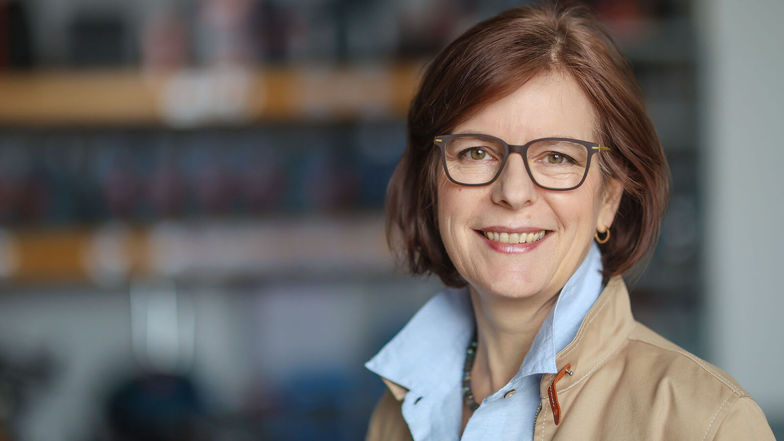 Porträt von Dorothée Schartz, eine Frau mittleren Alters mit brünetten, kinnlangen Haaren und großer Hornbrille.